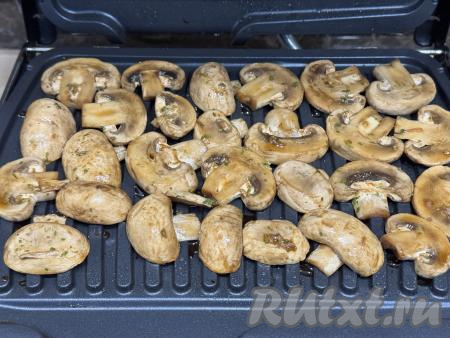Электрогриль разогреть на режиме № 1 "Овощи". Смазать створки электрогриля маслом, затем выложить замаринованные шампиньоны в один слой.&nbsp;
