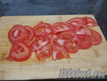 Помидор нарезаем на тонкие полукружочки.