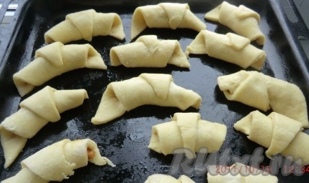 На каждый треугольничек из теста выложить кусочек вареной сгущёнки и скрутить в рогалик (как показано на фото). Выпекать наше печенье "Водолазы" в разогретой духовке до золотистого цвета.
