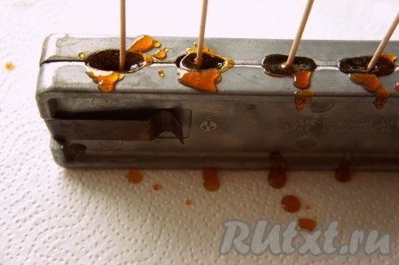 Горячую карамель (!) аккуратно разлить по формам. Вставьте специальные палочки (можно также использовать шпажки, зубочистки и т.д.) в леденцы и оставьте их до полного застывания карамели.