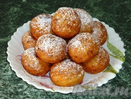 Готовые пончики посыпать сахарной пудрой.