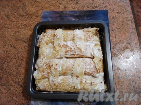 На каждый блин выкладываем начинку из мяса и грибов и сворачиваем блинчик рулетом. Эти рулеты слоями помещаем в форму, смазанную маслом. Сверху смазываем смесью сметаны и майонеза. Ставим в духовку на 20-25 минут.&nbsp;
