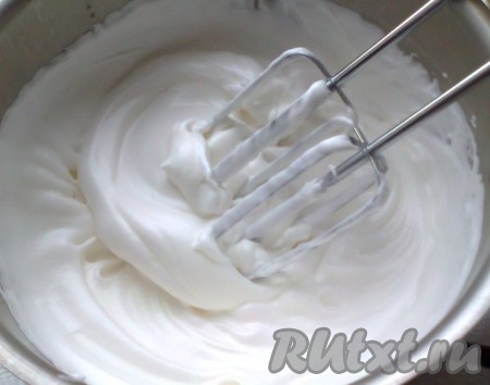 Испечённый корж достаём из духовки и оставляем остужаться. Теперь готовим крем белково-заварной (швейцарская меренга или "мокрое безе") на водяной бане из четырех белков. Готовим водяную  баню, для этого наливаем в кастрюлю воду так, чтобы миска с белками не касалась поверхности воды, доводим до кипения и уменьшаем огонь до минимума. Белки смешиваем с сахаром (всыпаем сразу весь) и устанавливаем над кастрюлей с водой. Мешаем непрерывно, без взбивания, пока весь сахар не растворится. Теперь начинаем взбивать на низких оборотах миксера, как только белок помутнеет, увеличиваем скорость. Взбиваем 5-7 минут до образования гладкой блестящей массы и достижения первой стадии готовности (поднятый венчик образует на поверхности небольшое возвышение, которое постепенно опадает). Чтобы не было очень сладко, можно добавить щепотку лимонной кислоты или 1 чайную ложку лимонного сока в конце взбивания. Снимаем белки с огня, устанавливаем в посуду с холодной водой (желательно - чтобы остановить процесс заваривания белка) и продолжаем взбивать до полного охлаждения белков (это займёт несколько минут).