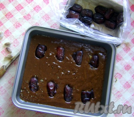 Вылить тесто на смазанную растительным маслом форму и вдавить финики так, чтобы при разрезании бананового пирога финики были по центру кусочка.