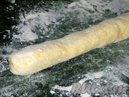 Рабочую поверхность посыпать мукой. Разделить тесто на 3 части. Из каждой части теста скатать руками колбаску.