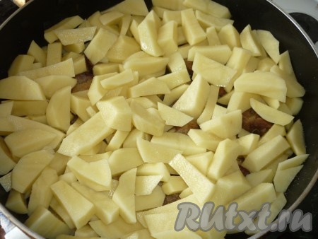 После того как мясо протушится 15-20 минут, добавляем в сковороду очищенный картофель, нарезанный на средние брусочки, перемешиваем, тушим минут 10 под крышкой. В процессе томления блюдо нужно будет 1-2 раза аккуратно перемешать. Посолить в процессе приготовления.