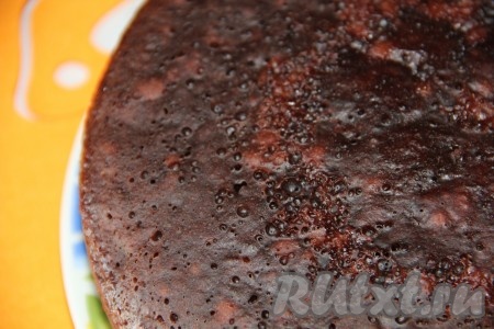 Форму для выпечки диаметром 24 сантиметра смазать растительным маслом, вылить тесто, разровнять, поставить форму в духовку, разогретую до 180 градусов, выпекать 40 минут (до готовности бисквита). Готовность выпечки можно проверить, проколов корж сверху сухой деревянной зубочисткой. Если зубочистка после прокалывания останется сухой и чистой, значит выпечка готова. Готовый бисквит достать из духовки, дать немного остыть, а затем переложить на решётку и оставить до полного остывания.