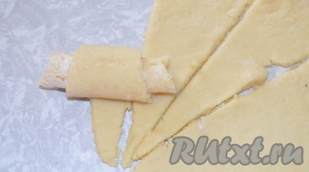 Каждый сегмент скрутите от широкого края к узкому, формируя печенье в виде рогалика.