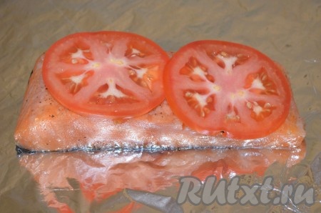 Из фольги сделать прямоугольник и сложить пополам, чтоб получился квадрат, в который без труда можно завернуть рыбу. И обязательно блестящей стороной вверх. Порезать помидор кольцами. Сыр либо потереть, либо нарезать пластинками. На фольгу кладем в центр рыбу, сверху на каждый кусок уложить помидоры.
