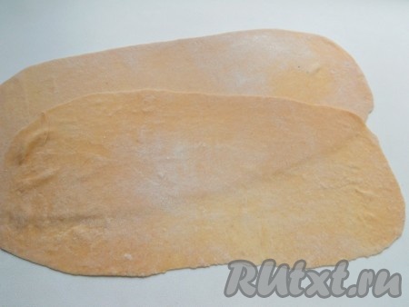 Каждую скатать в овал и раскатать очень тонко (постоянно подсыпая муку), в длину - примерно 30 см, в ширину - 15 см. Оставить на поверхности минут на 5-7, чтобы тесто подсохло.
