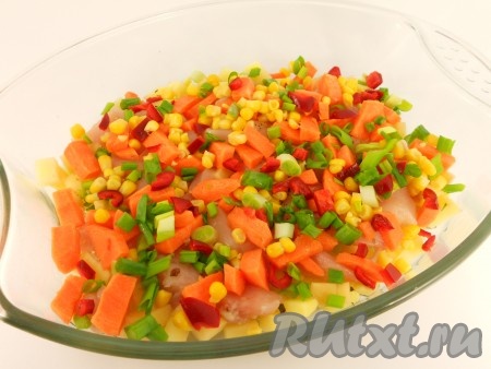 Далее, на курицу выложить порезанные кубиками - красный болгарский перец и морковь. Добавить кукурузу и измельченный зеленый лук.