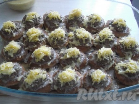 Через 15 минут достаём из духовки и посыпаем фаршированные сушки сыром. Ставим форму обратно в духовку ещё минут на 5-10.