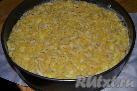 На яблоки вылить горячий пудинг, а сверху натереть замороженное тесто.
