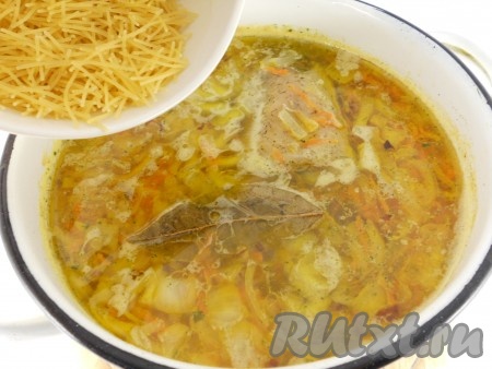 Добавить обжаренные овощи в кастрюлю, перемешать. Также добавить в кастрюлю порезанный кусочками чеснок и лавровый лист. Кипятить суп еще 5-7 минут, затем всыпать вермишель. Перемешать, суп прокипятить минуты 3 и выключить газ.