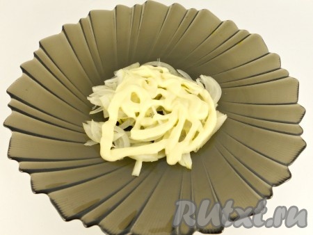 В салатник первым слоем выкладываем лук, смазываем майонезом.