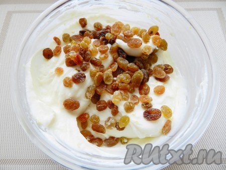 С лимона снять цедру. Изюм распарить в кипятке в течение 5 минут, затем обсушить. В творожную массу добавить изюм и цедру лимона, перемешать.
