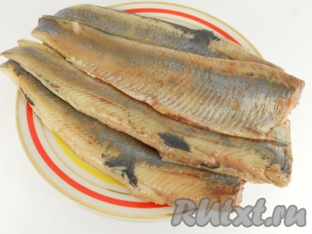 Солёную селёдку (я предпочитаю брать слабосолёную сельдь) очистить, удаляя голову, кожу, внутренности, промыть водой, отделить филе от костей. Обсушить филе рыбы.