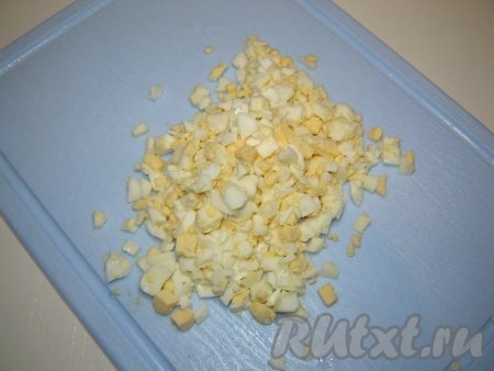 Мелко нарезать сваренные вкрутую яйца.