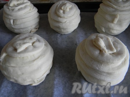 Слоёное тесто на слегка присыпанном мукой столе немного раскатать и нарезать на полоски шириной 1,5 сантиметра.&nbsp;Обернуть полосками теста яблоки внахлёст.&nbsp;Чтобы тесто лучше держалось, можно слегка увлажнить его водой.