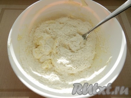 В получившуюся творожную массу всыпать грамм 150 муки и весь разрыхлитель, перемешать вилкой.