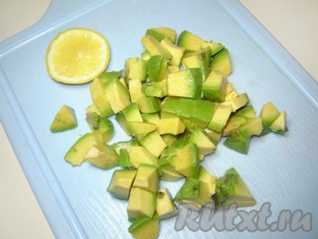 Авокадо разрезать пополам, удалить косточку и кожуру, порезать на кубики, сбрызнуть лимонным соком.