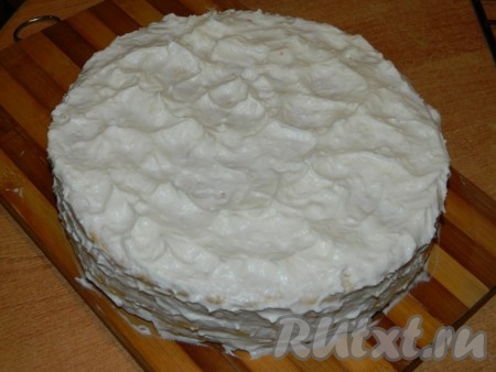 Обмазываем верх и бока песочного торта сливочным кремом.
