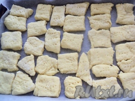 Раскатать тесто в пласт толщиной в палец и разрезать на квадраты. Выложить на противень, наколоть вилкой.