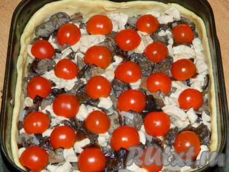 На тесто выкладываем курицу с грибами. Сверху, по желанию, раскладываем половинки помидоров.