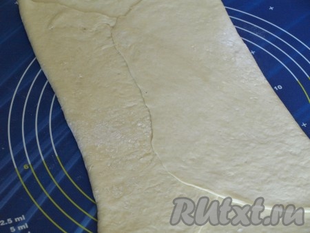 Затем тесто как можно тоньше раскатать в прямоугольник и меньшими сторонами сложить в центру, немного внахлёст.