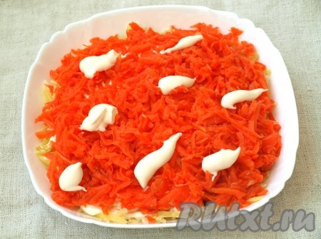 Картофель смазать майонезом и выложить сверху натёртую морковь.