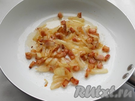 Добавить порезанный репчатый лук и обжарить до золотистости. Перед тем как выкладывать на сковороду лук, шпик по желанию можно удалить.
