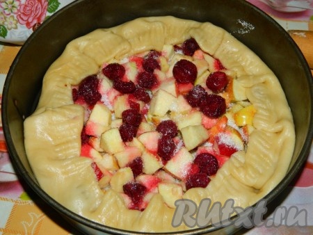 Пока песочное тесто отдыхает, займёмся начинкой для пирога. Вишню можно взять как свежую, так и замороженную. Свежие ягоды нужно промыть водой, удалить косточки.&nbsp;Замороженную вишню нужно разморозить, если есть косточки, их нужно будет удалить. Разложить подготовленную свежую (или размороженную) вишню на бумажном полотенце, дать немного обсохнуть. "Отдохнувшее" тесто на противне, застеленном пергаментом, раскатываем в большой круг (я формировала пирог на столе, а затем уже перекладывала в разъёмную форму, смазанную маслом, но гораздо удобнее формировать на застеленном противне). Яблоки моем, по желанию, очищаем от кожуры, нарезаем на небольшие кусочки, не затрагивая семенную коробочку с семечками. В середину раскатанного круга выкладываем нарезанные яблоки, поверх них раскладываем вишню. Края круга заворачиваем на начинку, оставляя центр песочного пирога открытым. Равномерно посыпаем яблочно-вишнёвую начинку сахаром. Противень (или форму для выпечки) отправляем в духовку, разогретую до 200 градусов. Выпекаем песочный пирог минут 30 (до подрумянивания теста).