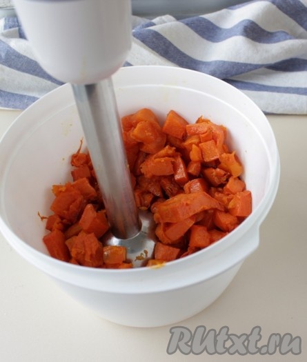 Убрать кастрюлю с тыквой с огня, если вода осталась, её нужно слить. Переложить варёную тыкву в глубокую миску. Пюрировать варёную тыкву погружным блендером до однородности.