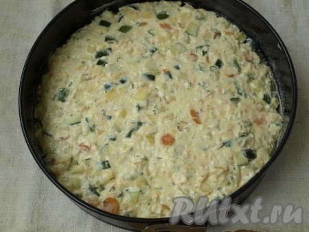 Разъёмную форму (у меня 28 см) смазать сливочным маслом и обсыпать манной крупой. Выложить смесь из овощей, курицы и творога, разровнять.