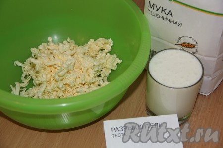 В глубокую миску натереть холодное сливочное масло на крупной тёрке, затем добавить соль, сахар, тщательно перемешать вилкой, влить кефир, перемешать. Всыпать разрыхлитель, небольшими порциями начать добавлять просеянную муку, замешивая тесто вначале ложкой, а затем продолжить замешивать его руками.