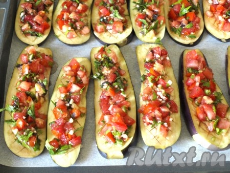 Поверх баклажанов равномерно разложить смесь помидоров, зелени и чеснока.