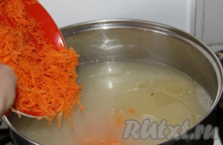 Добавляем очищенную и натёртую на крупной тёрке морковь. Даём рисовому супу закипеть, уменьшаем огонь и варим 20 минут (и картошка, и рис должны полностью свариться и стать достаточно мягкими).