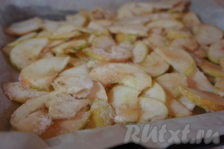 Форму для запекания застелить пергаментной бумагой, тонким слоем выложить яблоки, разровнять.
