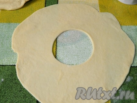 Раскатать второй кусочек теста в круг поменьше. В середине вырезать круг.
