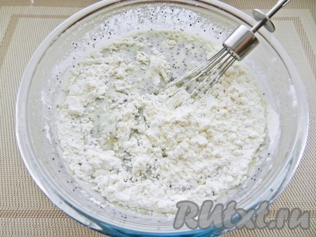 Добавить разрыхлитель, постепенно всыпать муку, каждый раз хорошо вмешивая её в тесто. Тесто должно получиться однородным, без комков, будет напоминать сметану средней густоты.