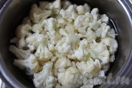 Цветную капусту промыть водой, разделить на соцветия. Переложить соцветия цветной капусты в кастрюлю, залить водой так, чтобы вода полностью покрыла капусту, поставить на сильный огонь. После закипания воды, добавить соль, уменьшить огонь, варить капусту минут 7-9 (цветная капуста должна стать мягкой, можно даже слегка переваренной).