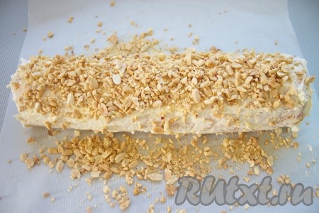 Поверхность рулета смазать остатками крема, посыпать измельченными орешками.