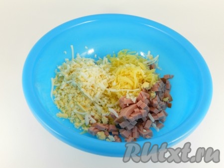 Отварные яйца и сыр натереть на крупной терке. Добавить нарезанную мелким кубиком или соломкой колбасу.