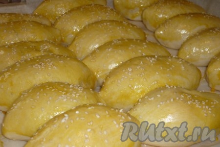 Достаём пирожки их из духовки, смазываем яйцом, предварительно взбитым вилкой, и, по желанию, посыпаем кунжутом.