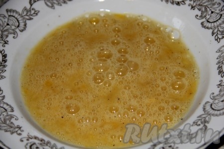 Для получения кляра разбиваем в достаточно объёмную миску сырые яйца, добавляем пропущенный через пресс чеснок, солим и перчим. Перемешиваем яичный кляр вилкой до однородности.