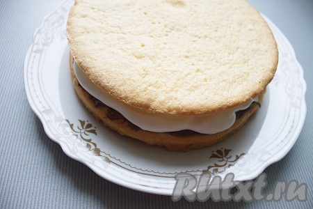 Накрыть вторым бисквитом, его смазать остатками сливок, посыпать тертым шоколадом.