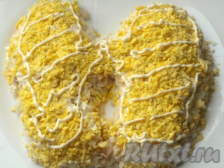 Яйца разделить на белки и желтки, натереть по отдельности на тёрке. Поверх яблока выложить желтки и смазать тонким слоем майонеза.
