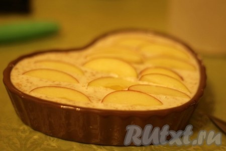 Яблоко нарезать на тонкие дольки и выложить в один слой поверх запеканки.