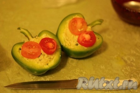 Наполнить половинки перцев капустной начинкой. Помидор нарезать на кружочки и выложить сверху на половинки перцев. Слегка присолить прмидоры.