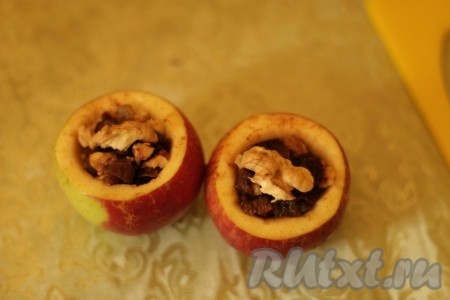 Плотно заполнить яблоки начинкой.